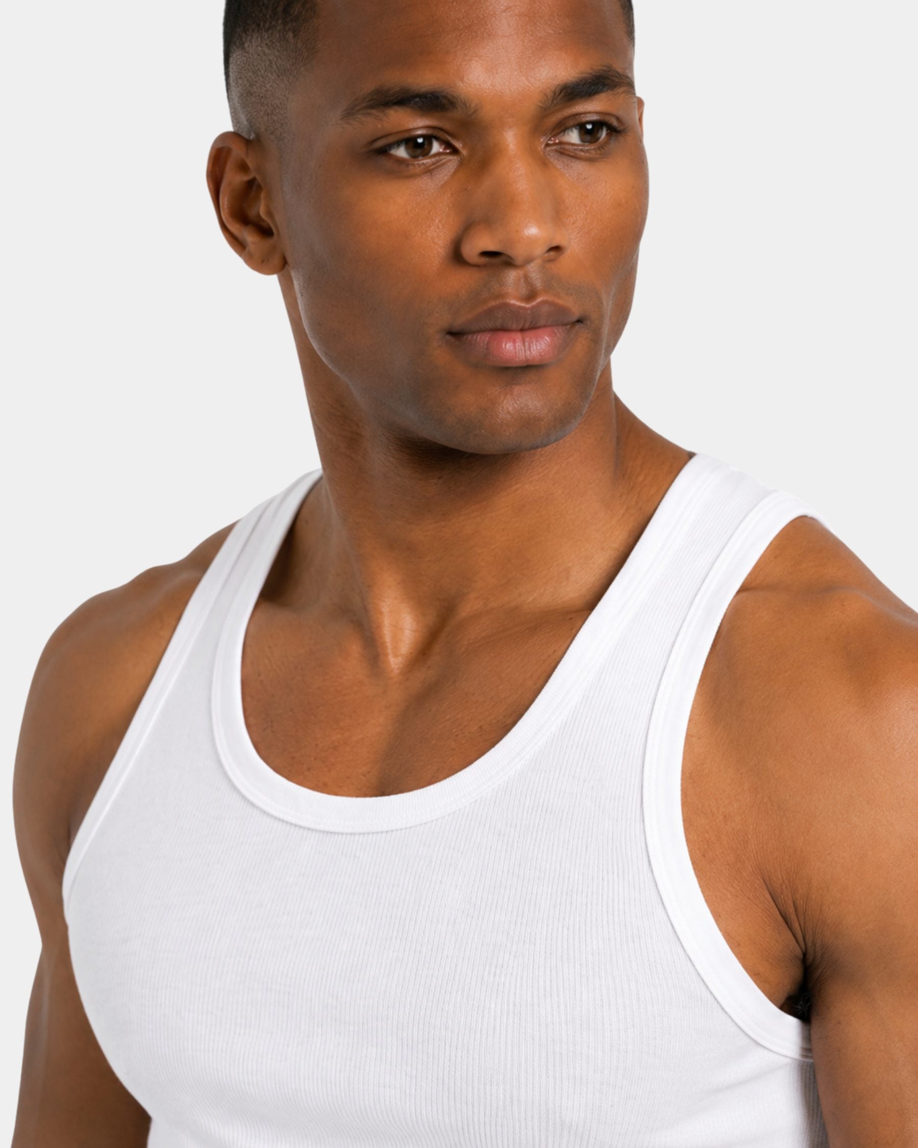 By Alden white ribbed tank top on male model, close-up detail of neckline and shoulder, light gray background #Color_white