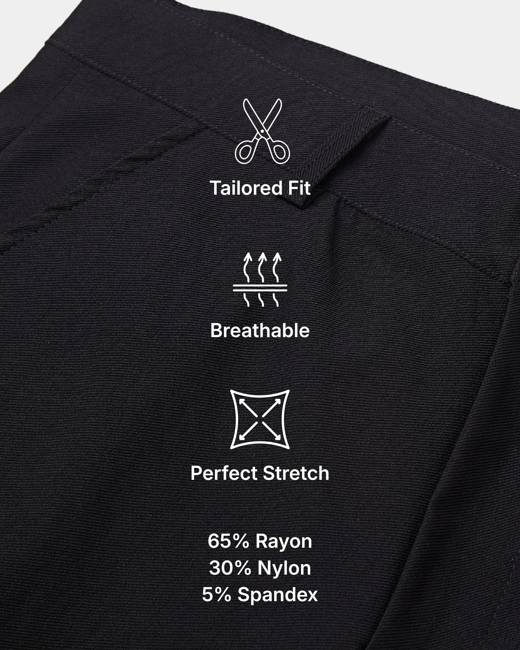 Close-up of black fabric with white printed feature icons and text reading 'Tailored Fit,' 'Breathable,' 'Perfect Stretch,' and material percentages '65% Rayon,' '30% Nylon,' '5% Spandex.'.