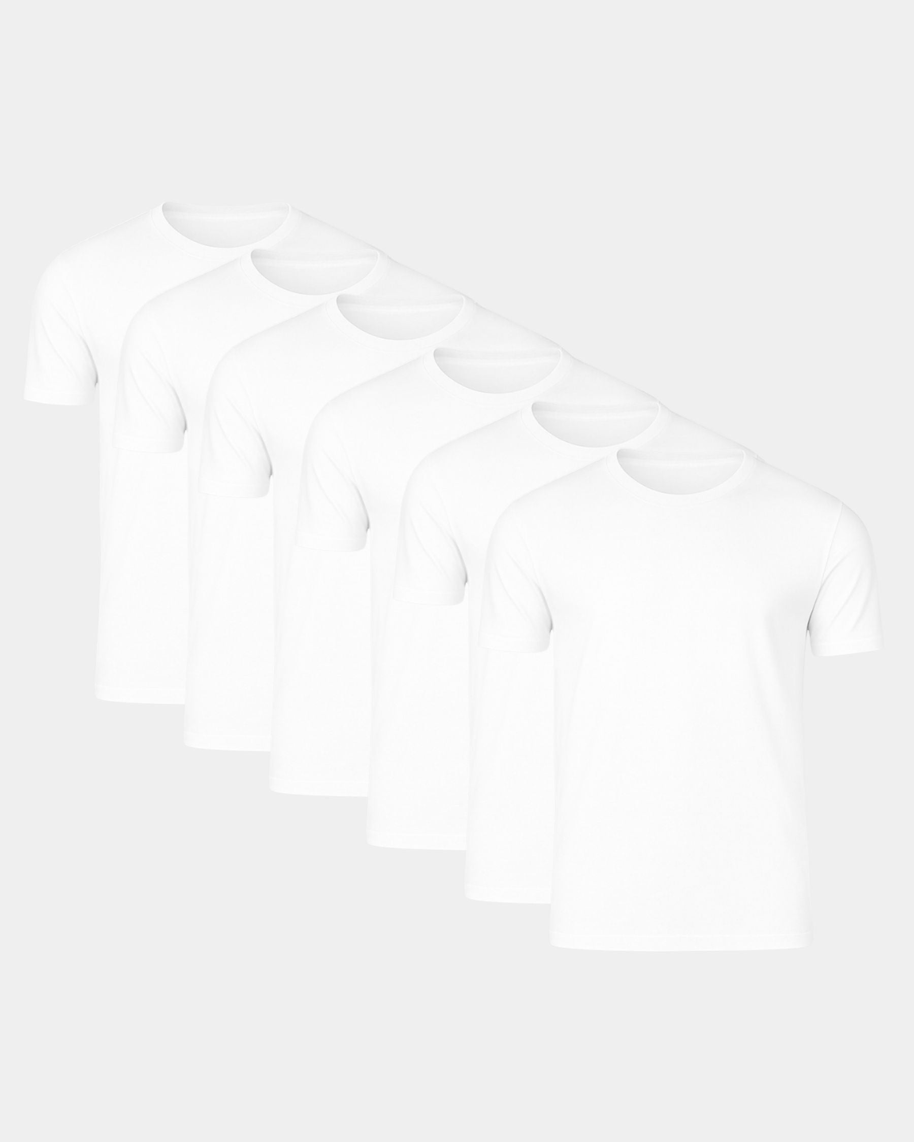 Five plain white short-sleeve crew-neck T-shirts arranged in a staggered diagonal row on a light gray background.
