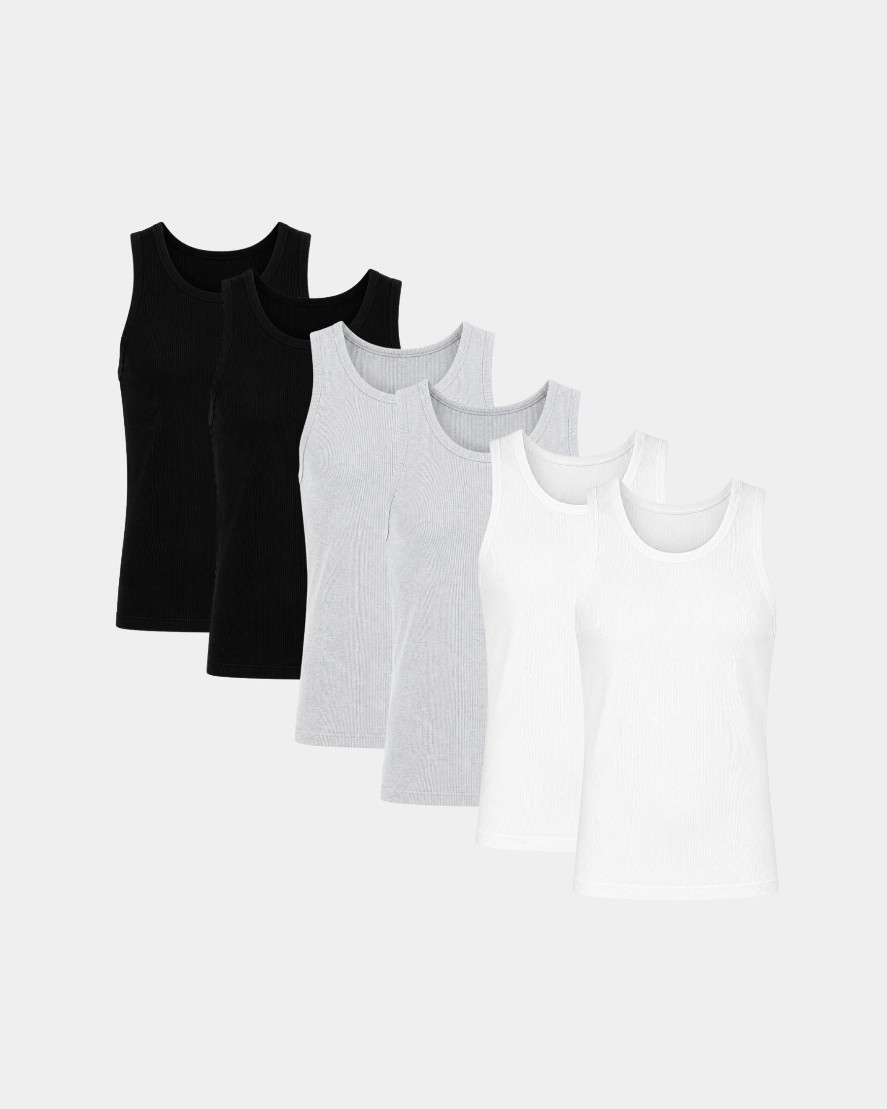 Five sleeveless tank tops in black, light gray, and white, arranged in a staggered row on a light gray background.