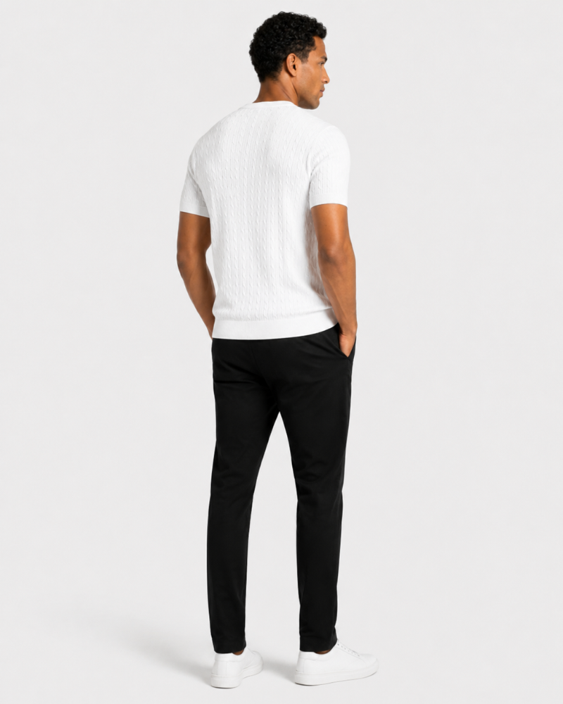 Man wearing a By Alden white t-shirt and black pants on a white background #color_white
