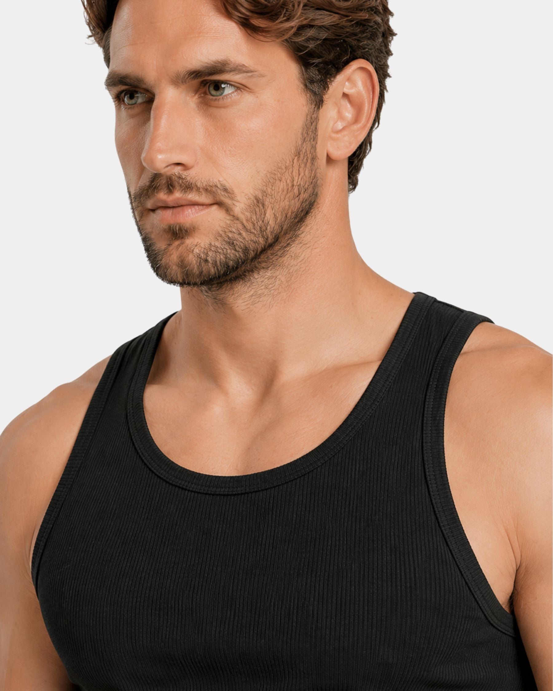 Man wearing a black tank top against a plain background