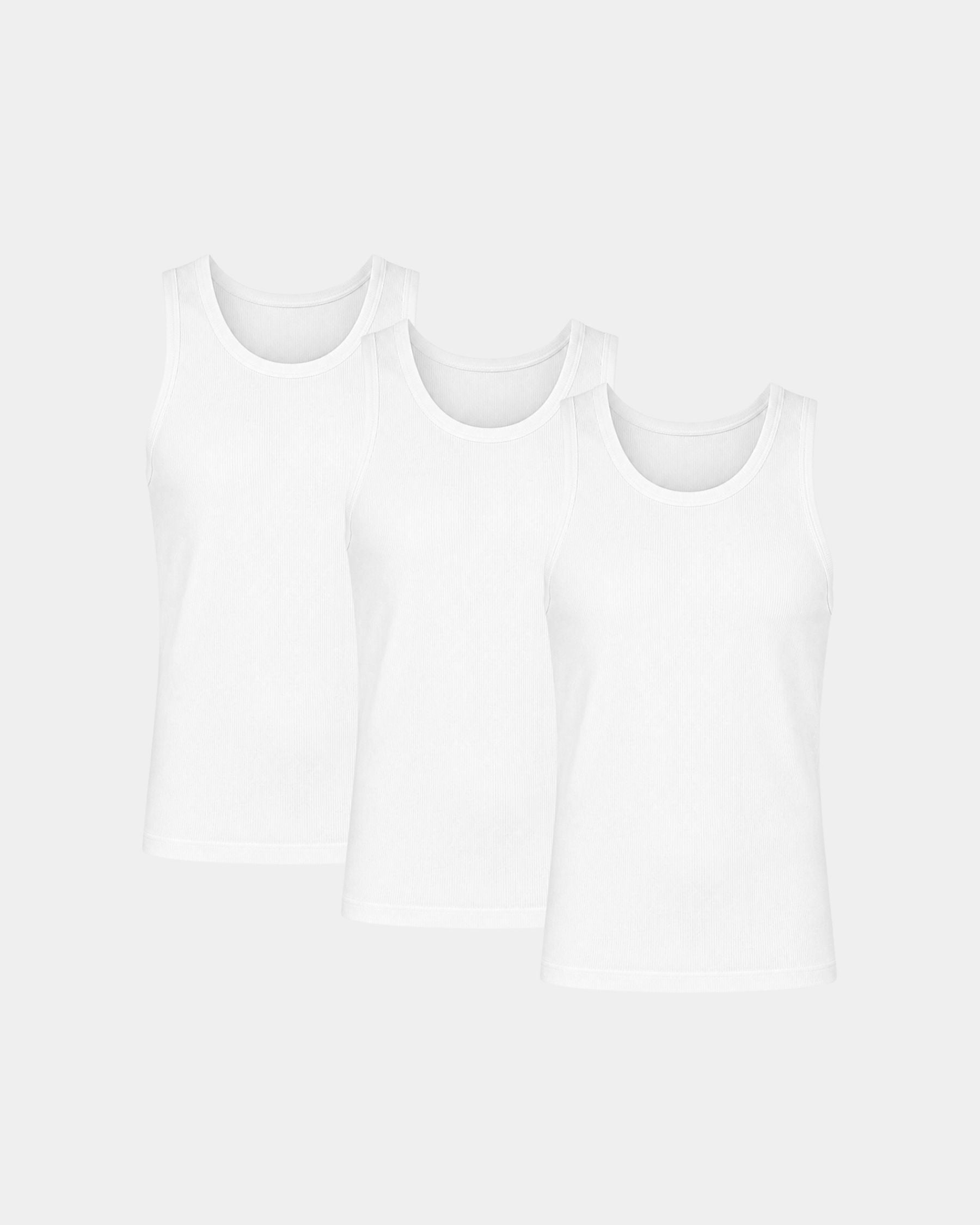 Three white sleeveless tank tops arranged in a staggered overlapping layout on a light gray background.